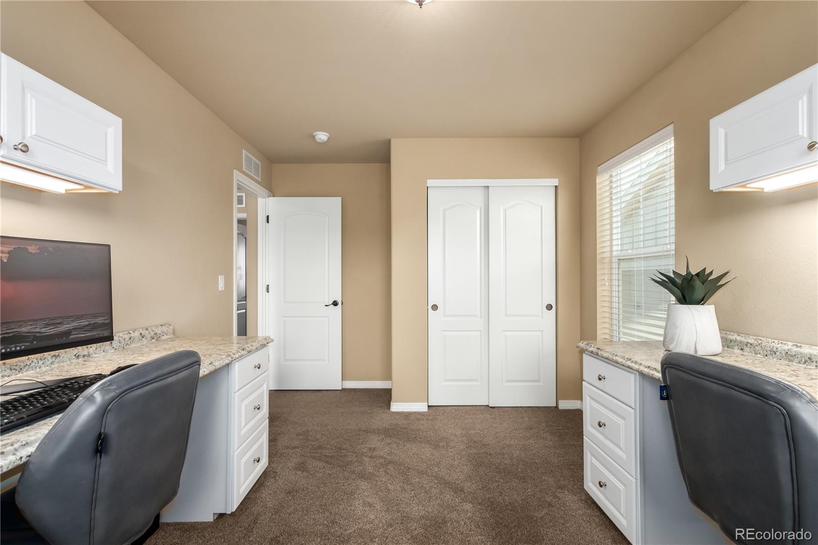 24389 East Brandt Avenue Aurora, CO 80016 - Photo 30 of 49 a living room with furniture and a flat screen tv