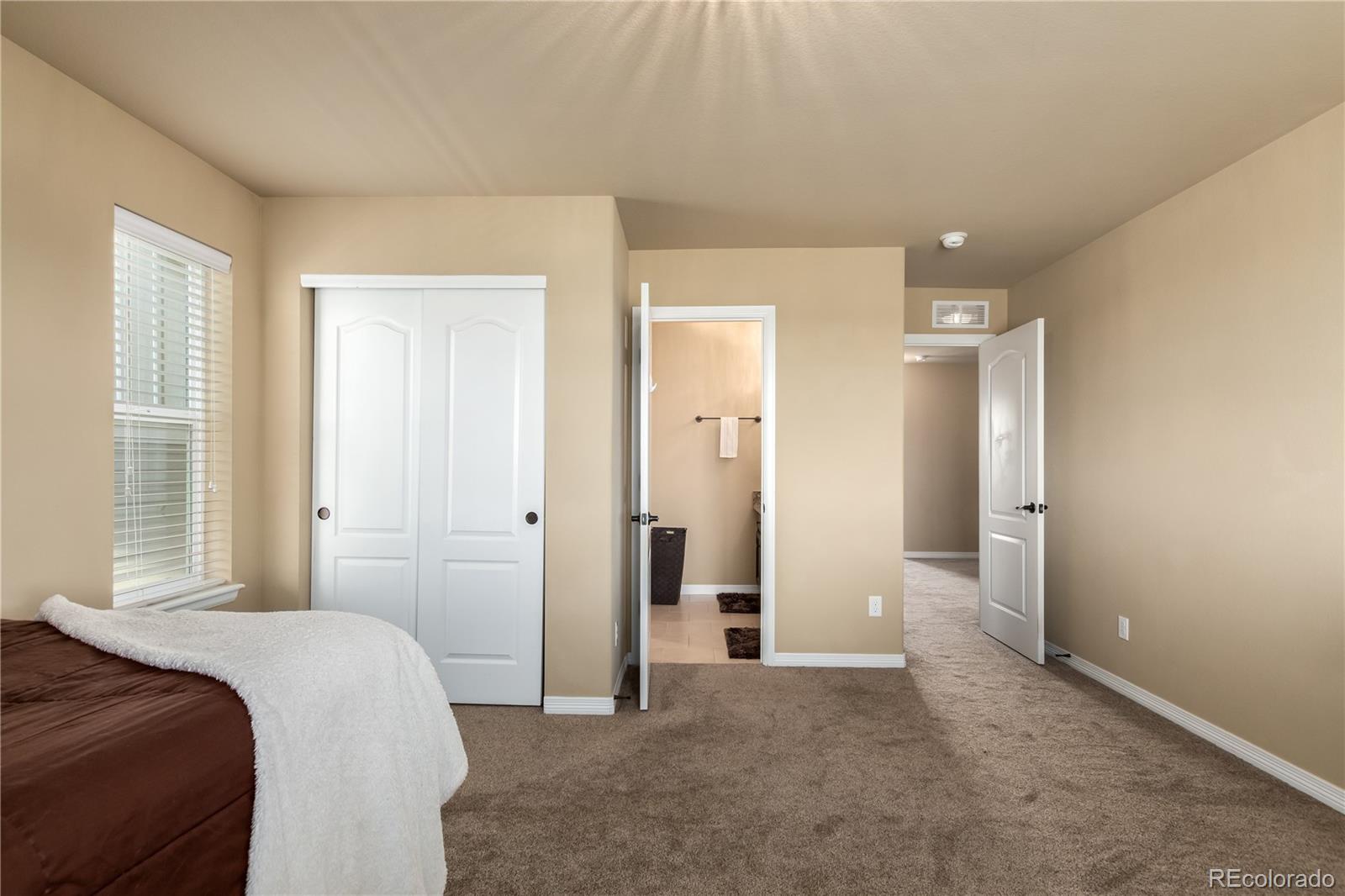24389 East Brandt Avenue Aurora, CO 80016 - Photo 32 of 49 a bedroom with a bed and a window