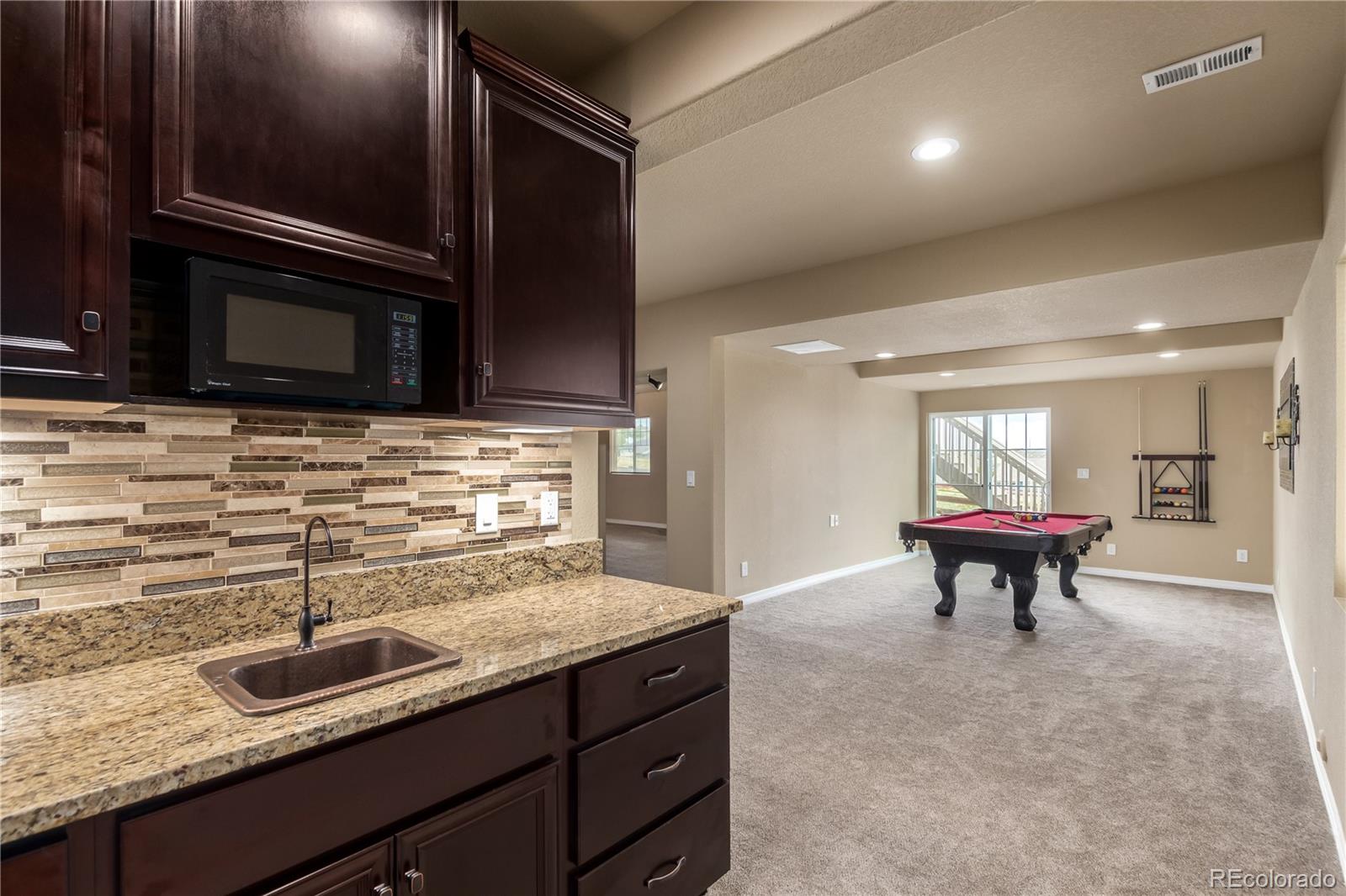 24389 East Brandt Avenue Aurora, CO 80016 - Photo 38 of 49 a kitchen with a sink and cabinets