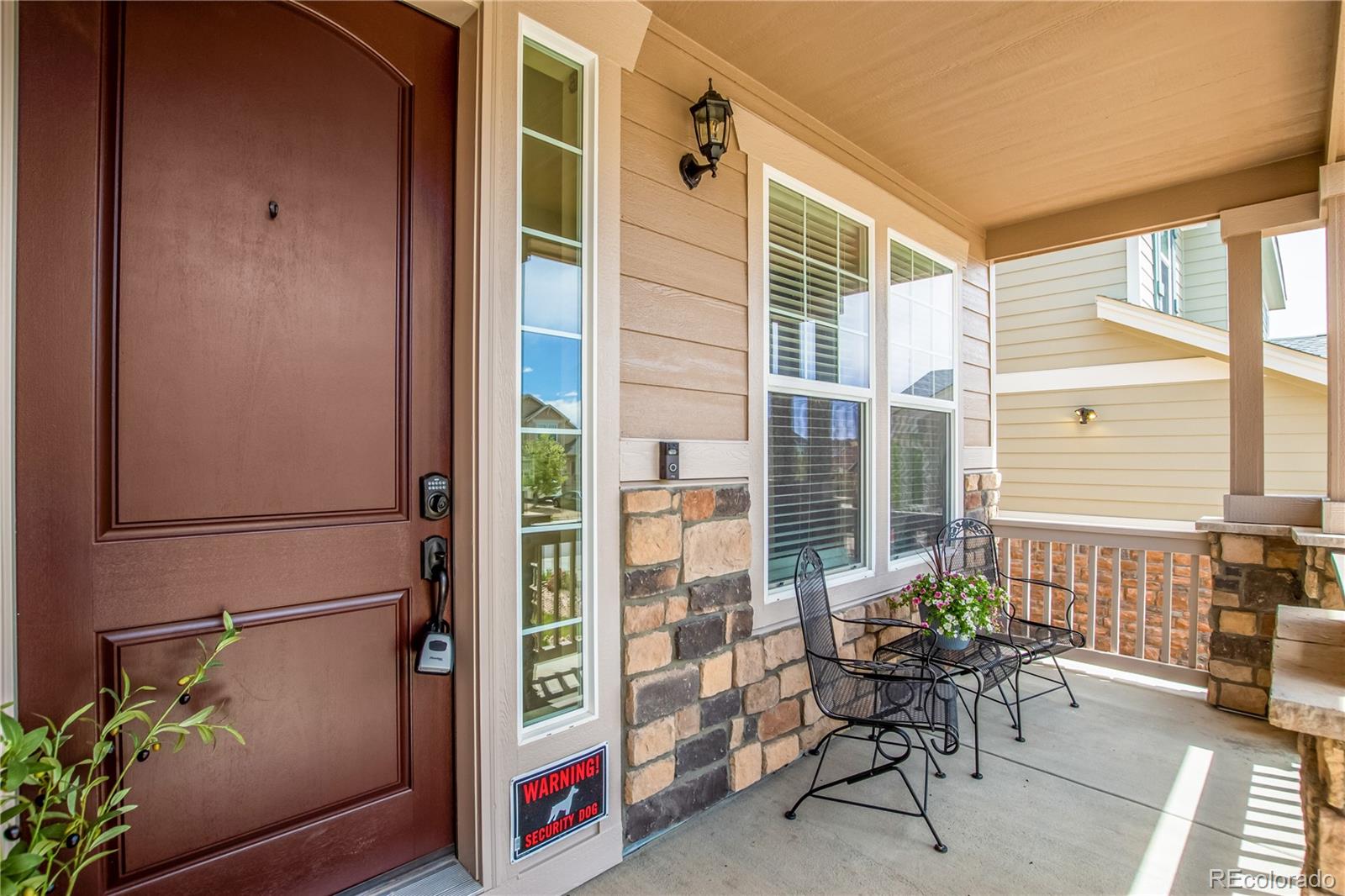 24389 East Brandt Avenue Aurora, CO 80016 - Photo 4 of 49 a balcony with furniture and a potted plant