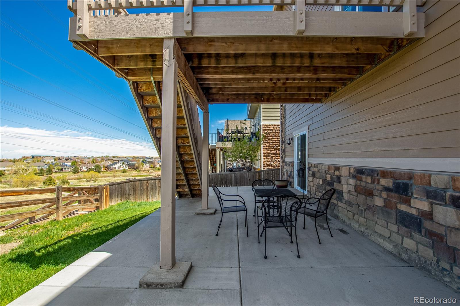 24389 East Brandt Avenue Aurora, CO 80016 - Photo 44 of 49 a view of a patio with a table and chairs under an umbrella