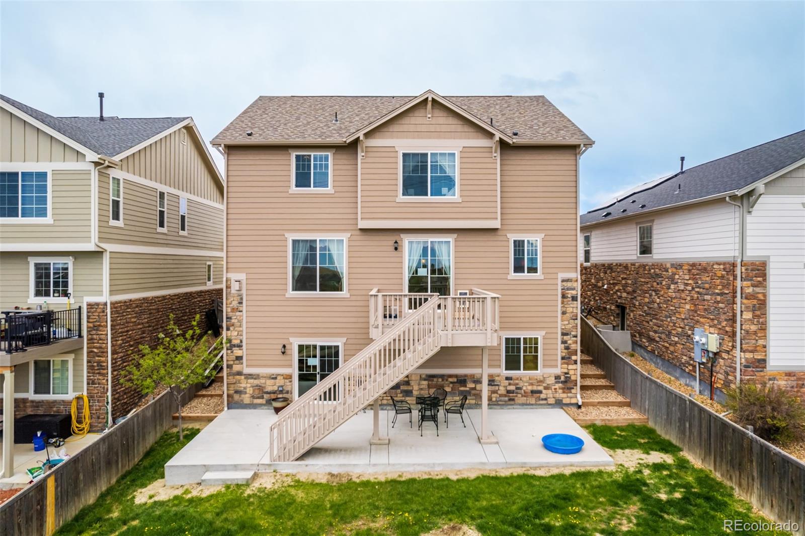 24389 East Brandt Avenue Aurora, CO 80016 - Photo 45 of 49 a view of a house with backyard porch and wooden fence