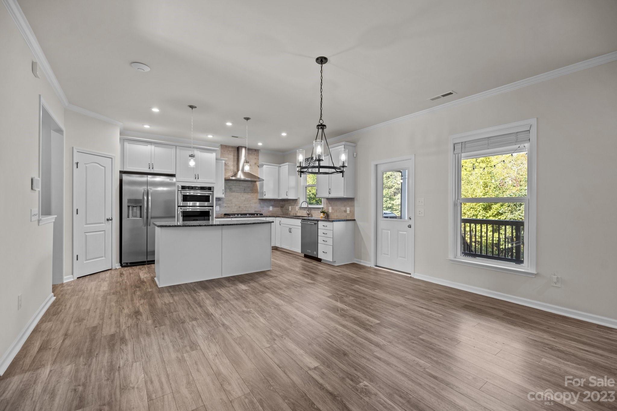 137 Hampton Trail Drive Fort Mill, SC 29708 - Photo 16 of 48 a view of kitchen with refrigerator microwave and wooden floor
