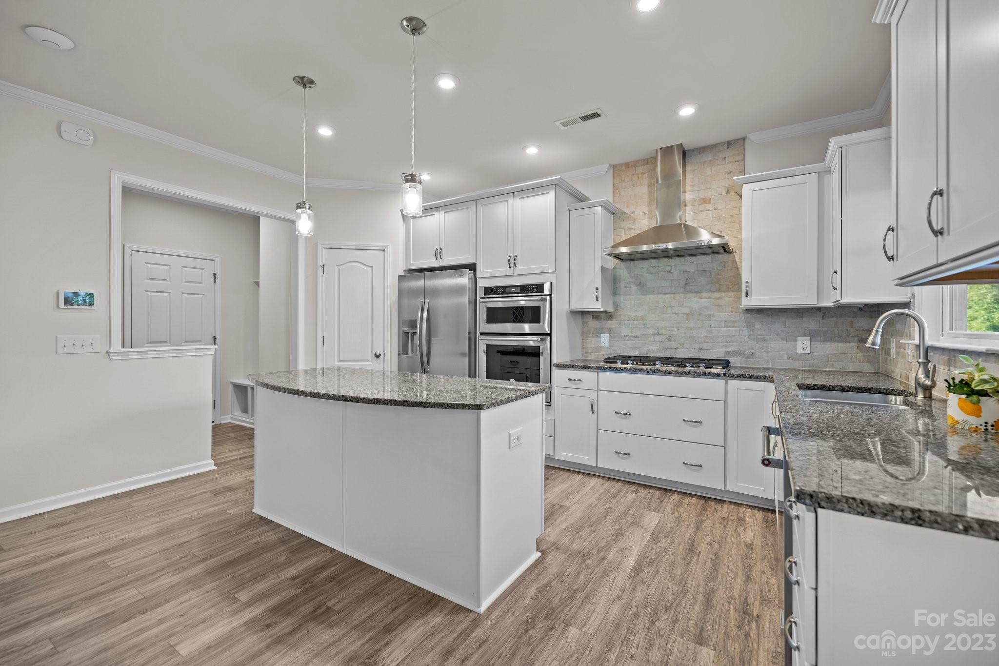 137 Hampton Trail Drive Fort Mill, SC 29708 - Photo 18 of 48 a kitchen with stainless steel appliances granite countertop a stove a sink and white cabinets