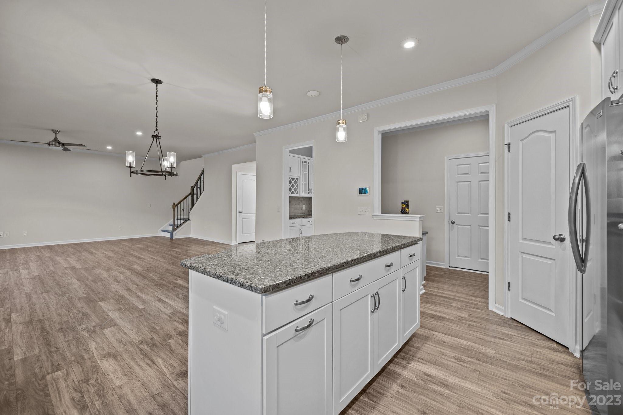 137 Hampton Trail Drive Fort Mill, SC 29708 - Photo 19 of 48 a kitchen with a granite countertop sink refrigerator and wooden floor