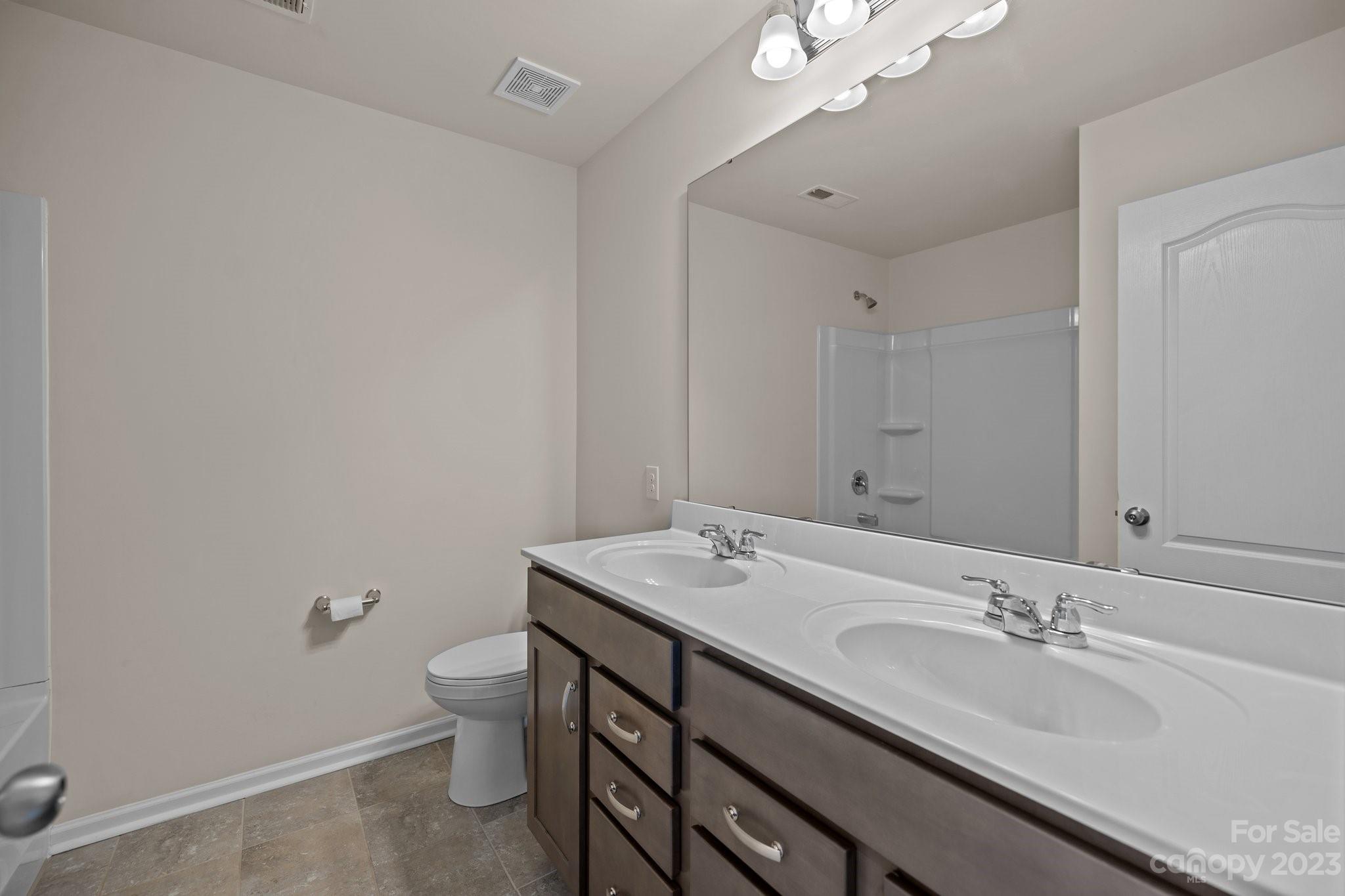 137 Hampton Trail Drive Fort Mill, SC 29708 - Photo 30 of 48 a bathroom with a granite countertop sink a toilet and a mirror