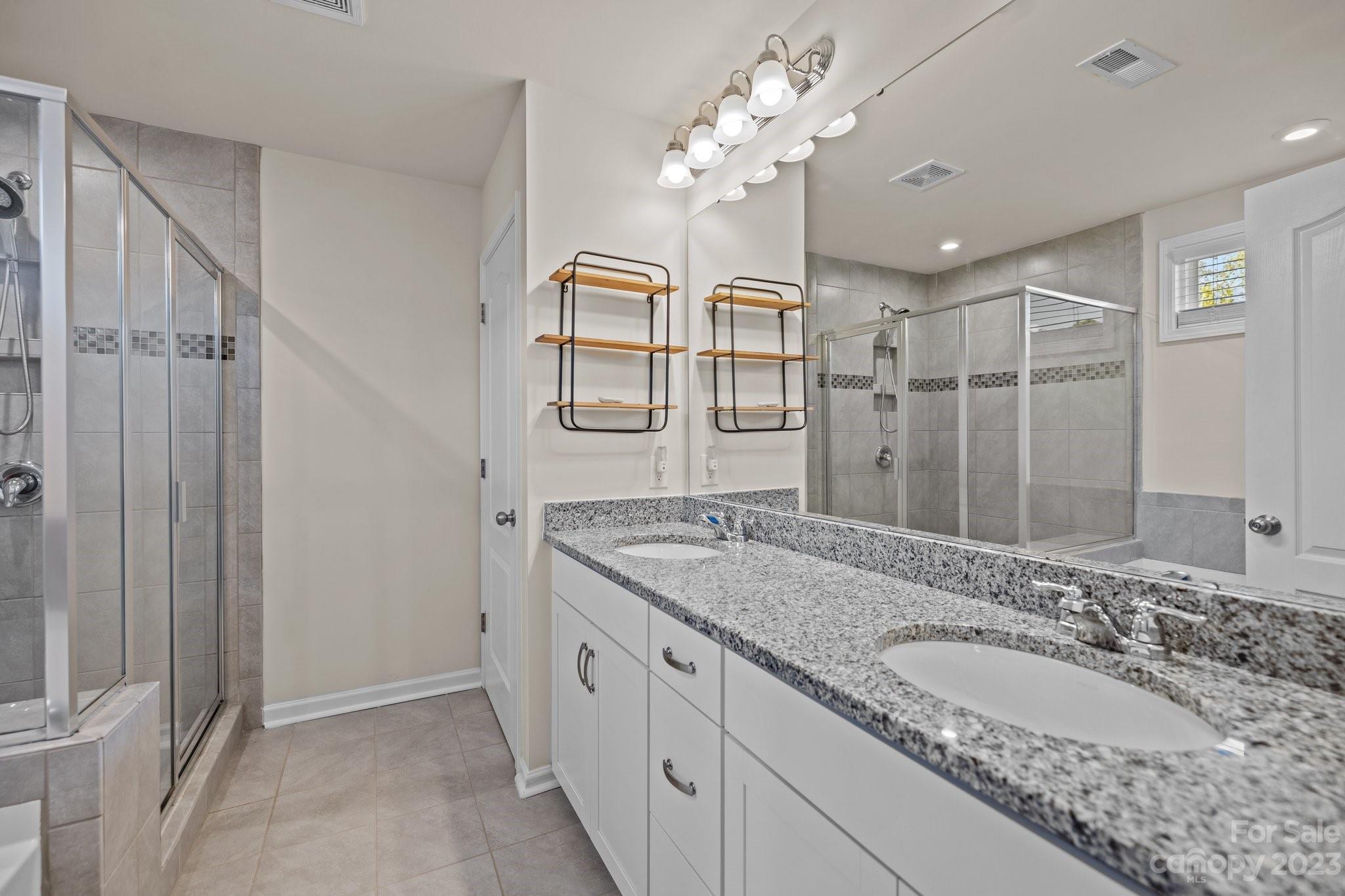 137 Hampton Trail Drive Fort Mill, SC 29708 - Photo 34 of 48 a bathroom with a granite countertop double vanity sink a mirror and a shower