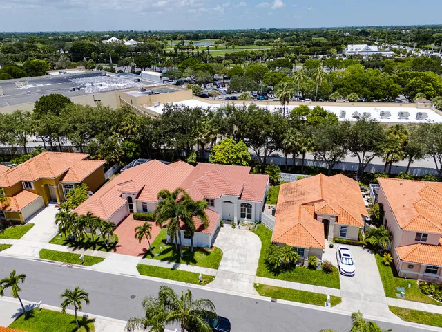 an aerial view of a house with a yard