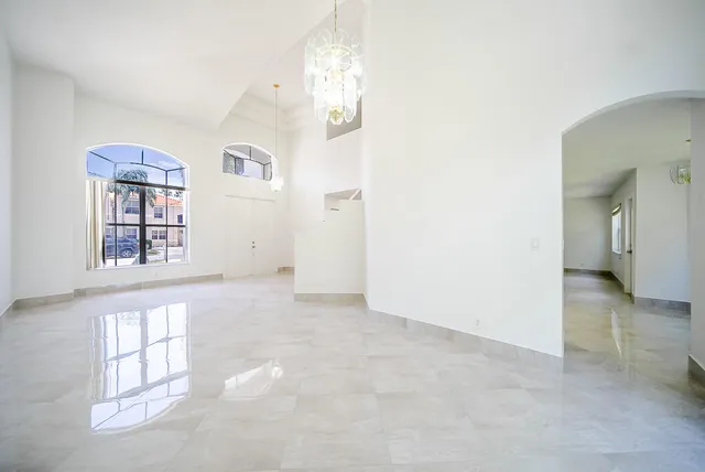 an empty room with windows and entrance