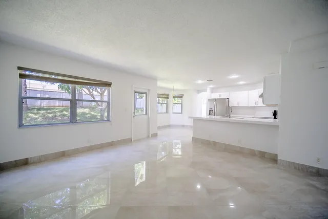 a kitchen with kitchen island sink stove and cabinets