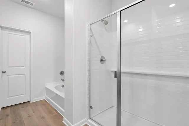 a bathroom with a bathtub and shower