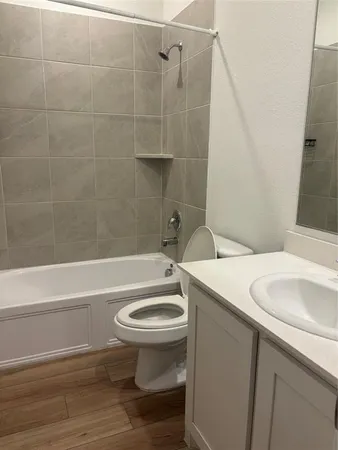 a bathroom with a sink a toilet and bathtub
