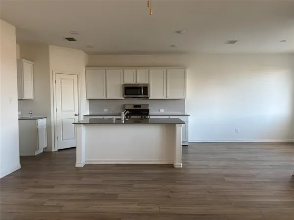 a view of a kitchen with sink and microwave