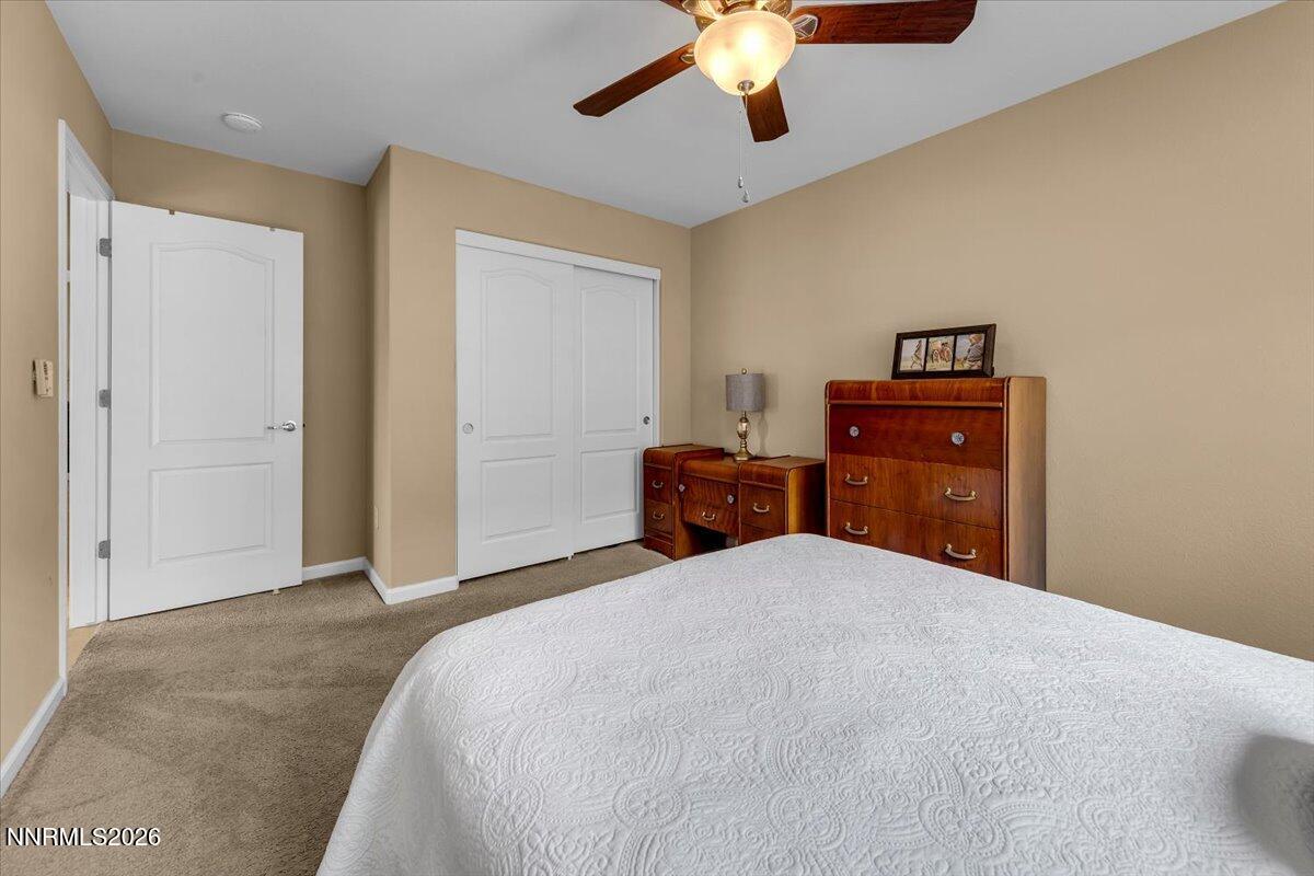 104 Bethpage Road Dayton, NV 89403 - Photo 33 of 65 a bedroom with a bed and a chandelier