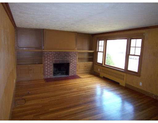 20 Penrose Street Springfield, MA 01109 - Photo 8 of 12 a view of an empty room with wooden floor fireplace and a window