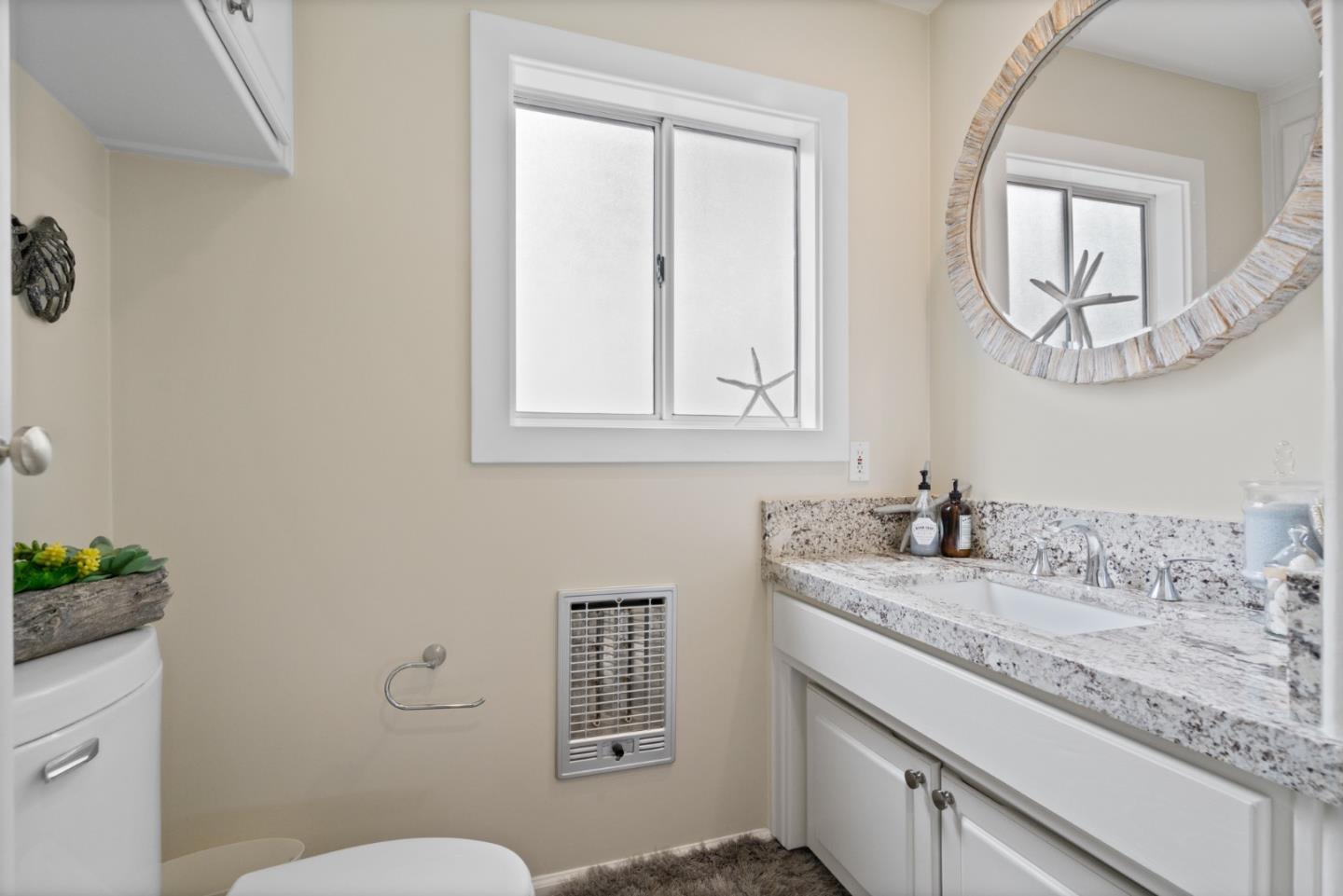 57 Sunset Drive Watsonville, CA 95076 - Photo 28 of 44 a bathroom with a granite countertop sink mirror vanity and toilet