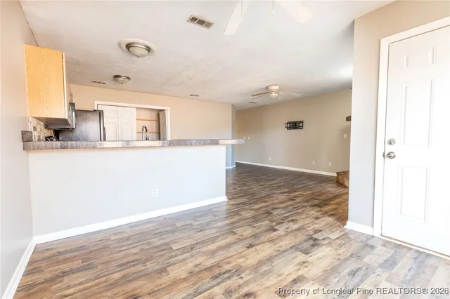 a view of a kitchen with a sink and wooden floor