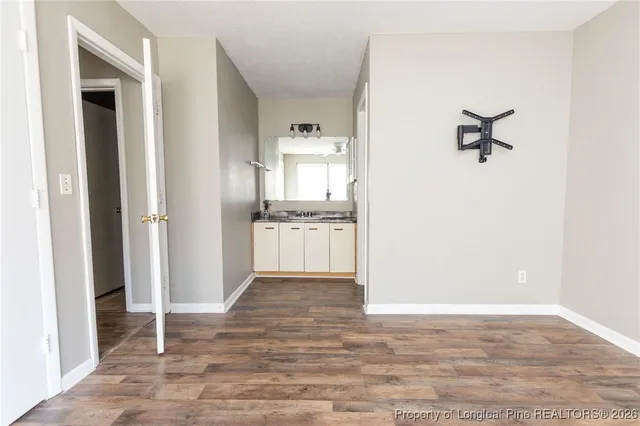 a view of a kitchen from the hallway with a sink