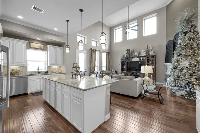 a kitchen with granite countertop cabinets stainless steel appliances and a sink