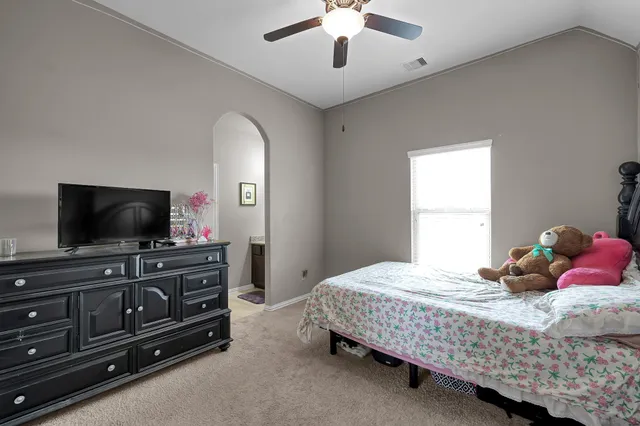 a bedroom with a bed and a chandelier