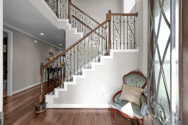 a view of entryway and hall with wooden floor