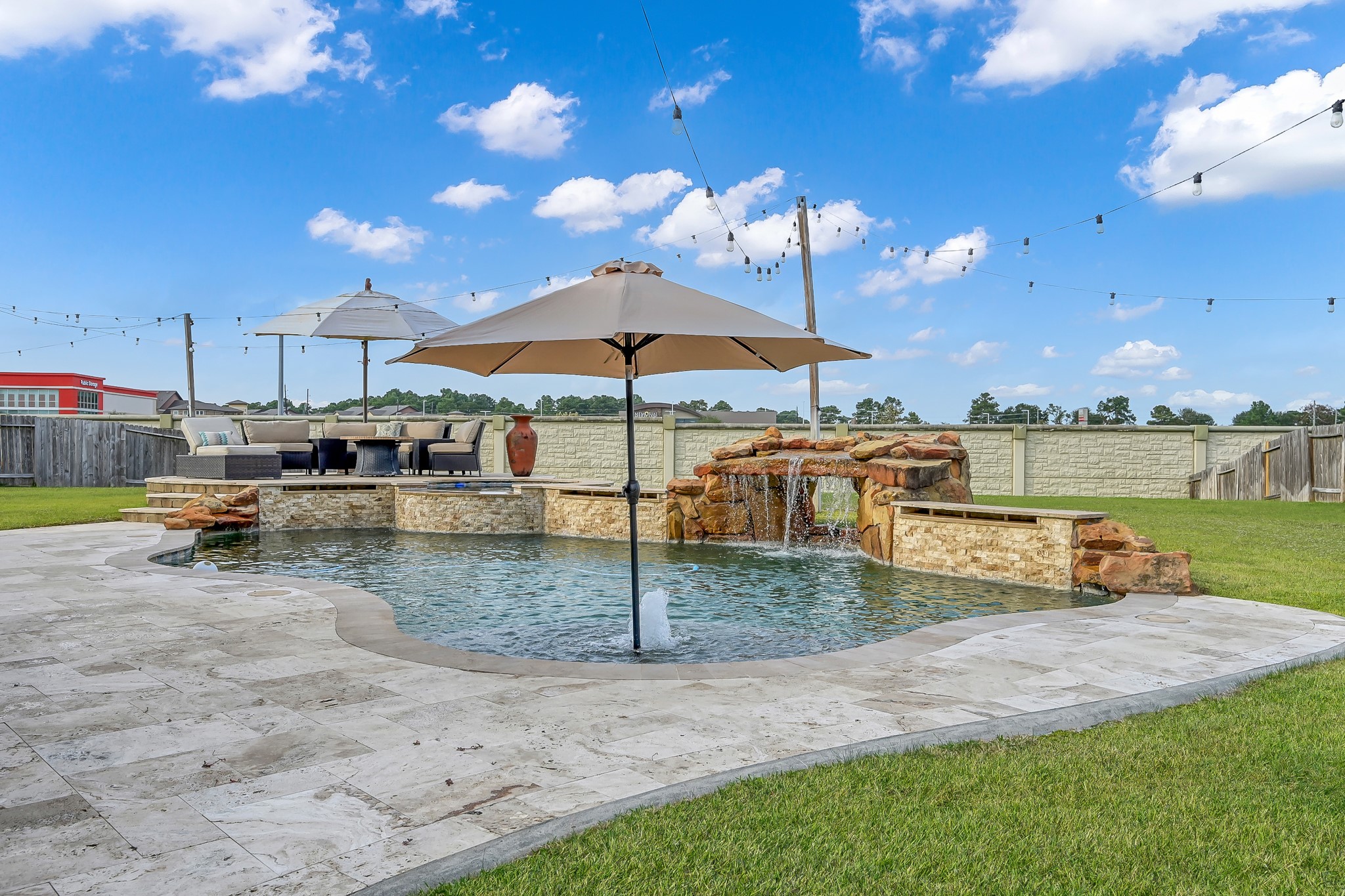 21926 Shamion Court Spring, TX 77379 - Photo 45 of 50 Pool has a tanning ledge with a bubbler and wet edge lining.