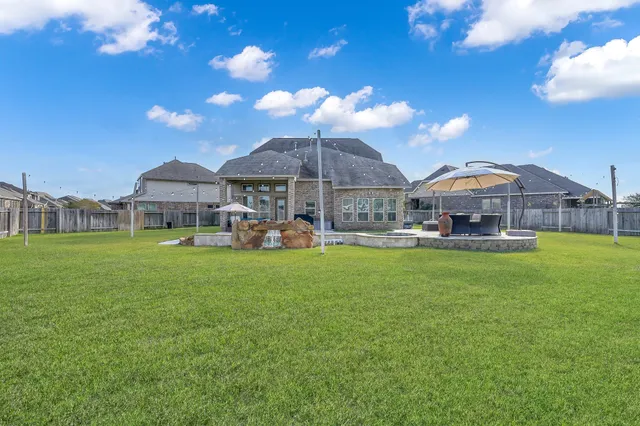 a view of a house with swimming pool and a yard