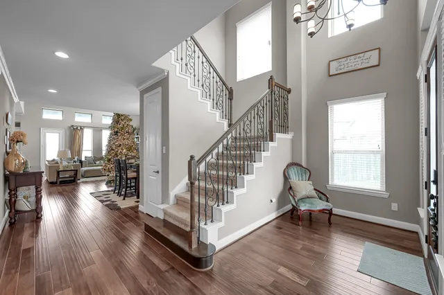 a view of entryway and hall with wooden floor