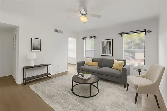 a living room with furniture potted plant and a window
