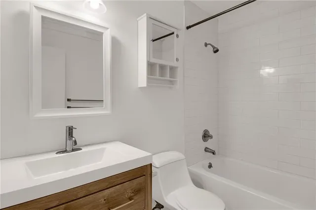 a bathroom with a sink toilet a mirror and shower