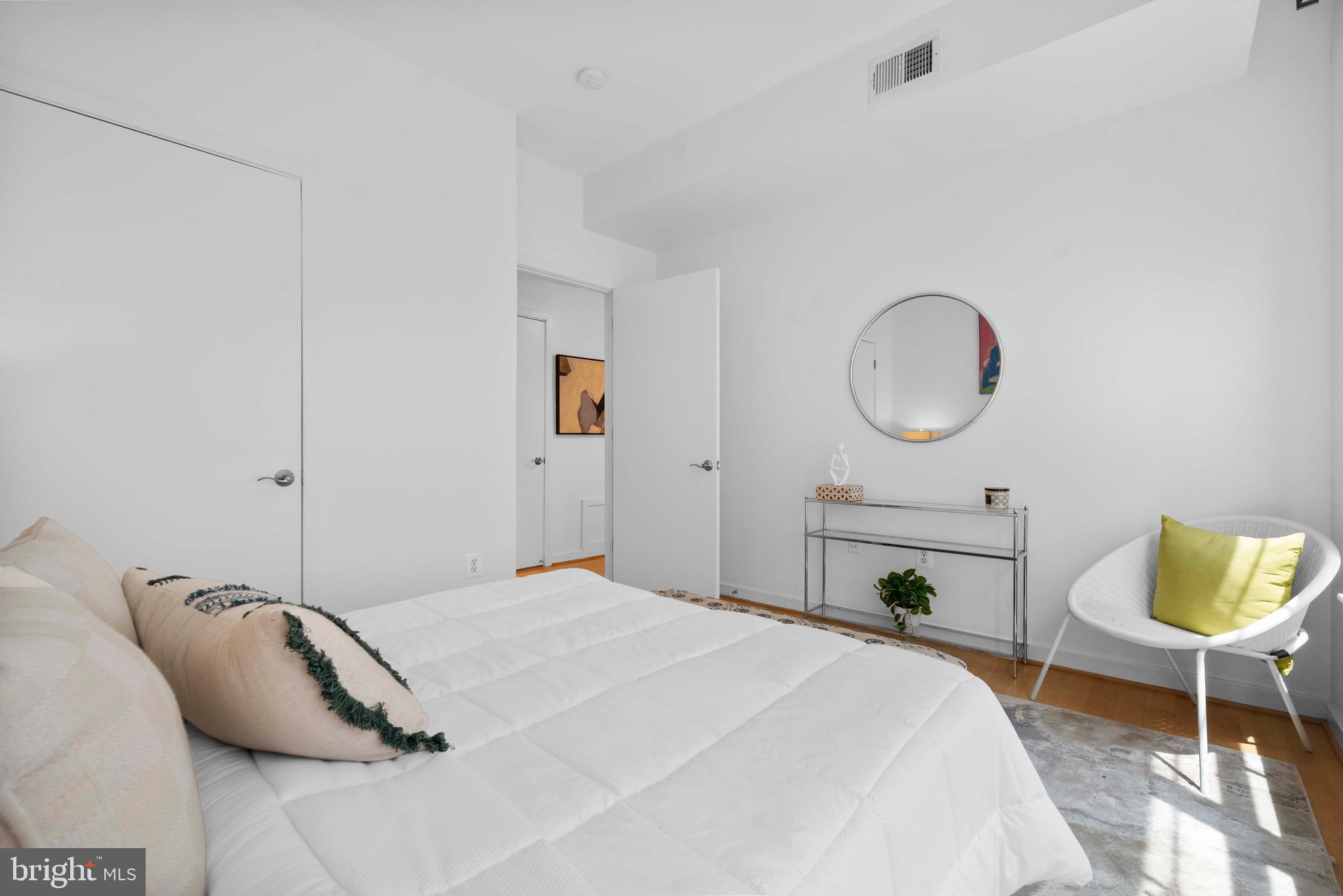 2412 17th Street Northwest, Unit 102 Washington, DC 20009 - Photo 15 of 21 a bedroom with a bed and a chandelier