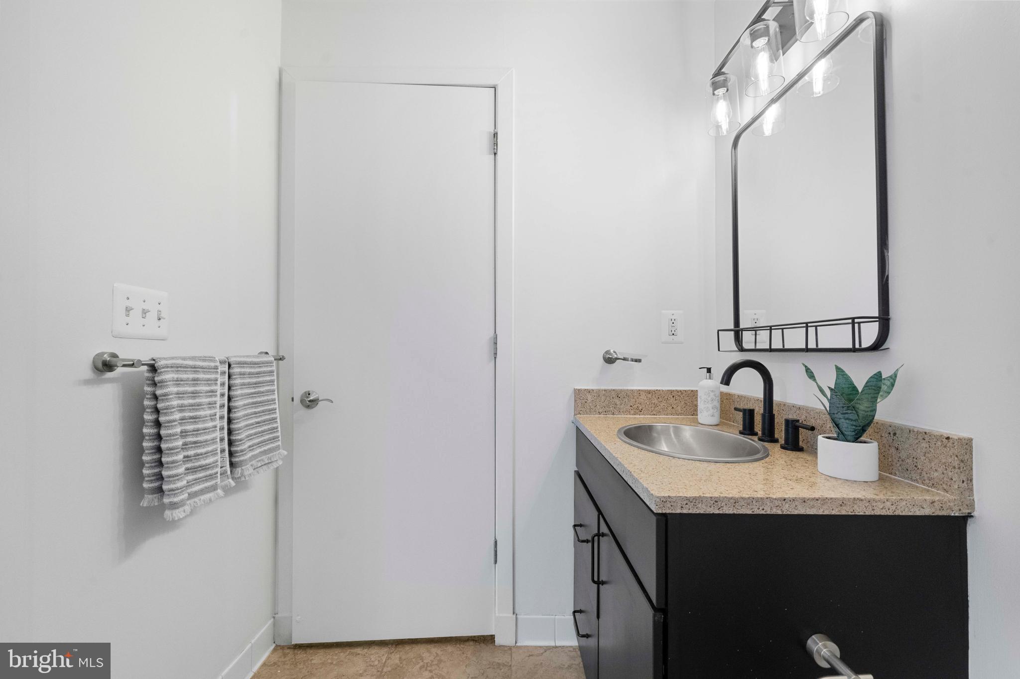 2412 17th Street Northwest, Unit 102 Washington, DC 20009 - Photo 16 of 21 a bathroom with a sink and a mirror