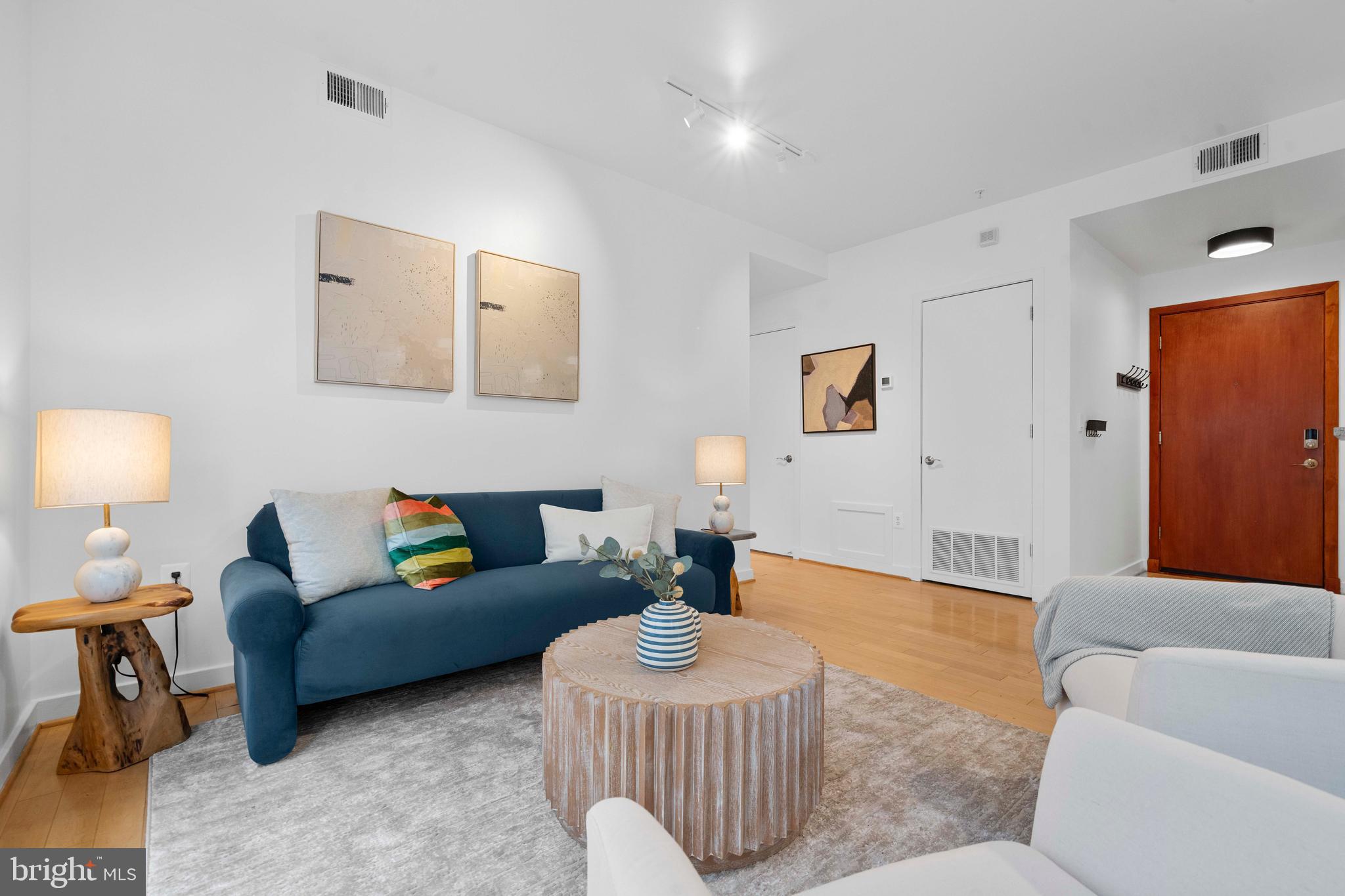 2412 17th Street Northwest, Unit 102 Washington, DC 20009 - Photo 6 of 21 a living room with furniture and a lamp