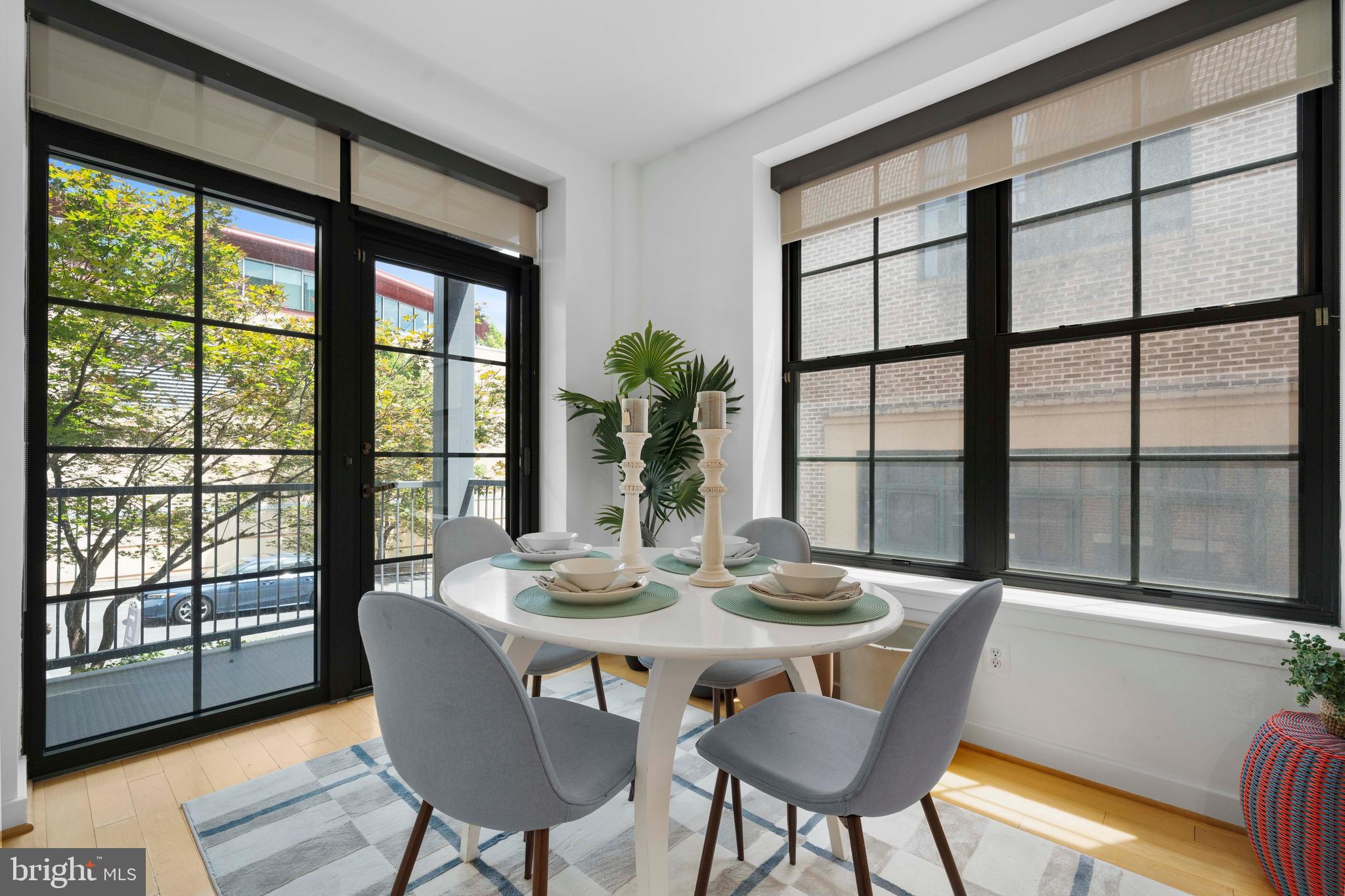 2412 17th Street Northwest, Unit 102 Washington, DC 20009 - Photo 8 of 21 a view of a dining room with furniture large windows and wooden floor