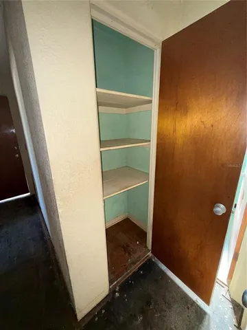 a room with walk in closet and window