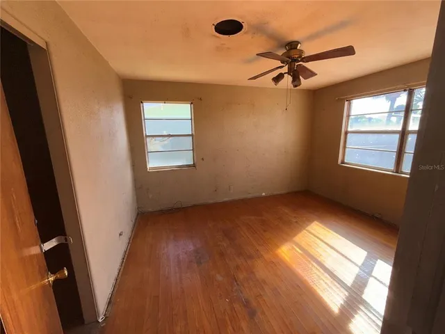 a view of an empty room and a window