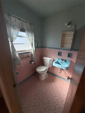 a bathroom with a toilet and a sink