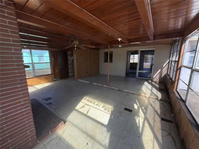 a view of an empty room with a fireplace