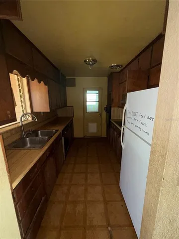 a kitchen with a refrigerator and a stove