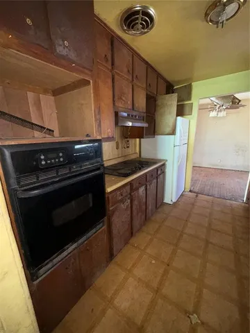 a kitchen with a stove and a refrigerator