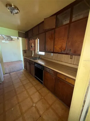 a kitchen with stainless steel appliances a sink stove and cabinets