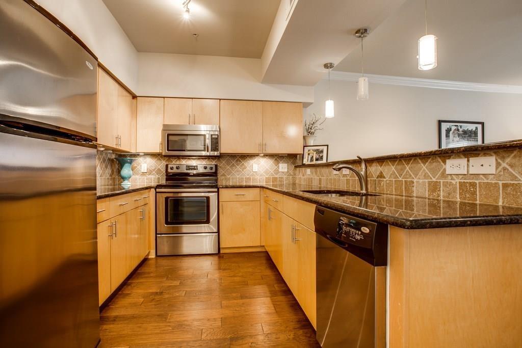 3102 Kings Road, Unit 3310 Dallas, TX 75219 - Photo 6 of 19 a kitchen with granite countertop a sink and stainless steel appliances