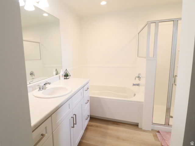 8240 Cascade Vw Way Magna, UT 84044 - Photo 9 of 18 Bathroom with vanity, light wood finished floors, a stall shower, a garden tub, and recessed lighting