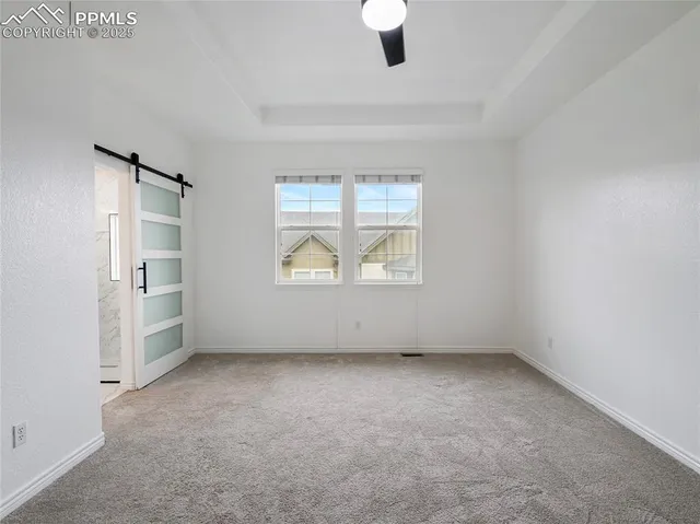 an empty room with closet and windows