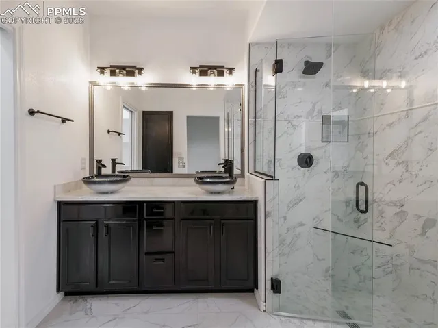 a bathroom with a shower sink and mirror
