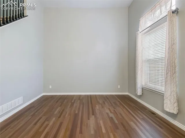a view of a room with wooden floor and brick walls