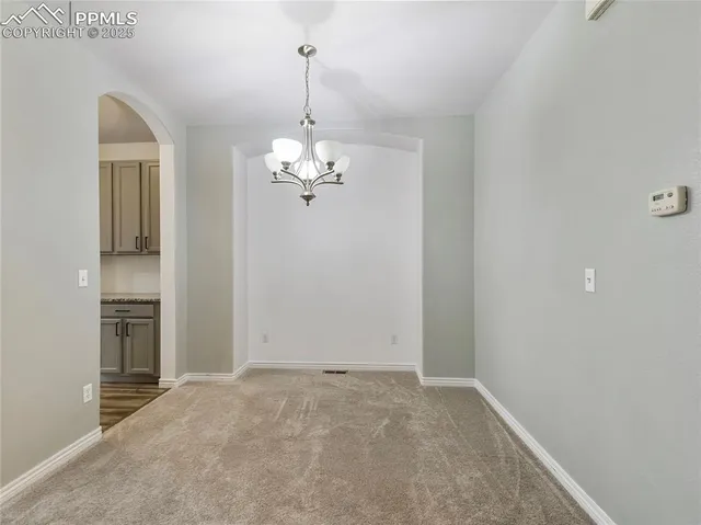 a view of a chandelier in big room and chandelier