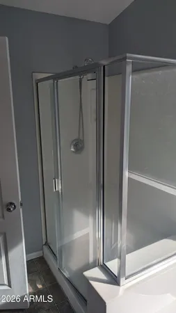 a bathroom with a glass shower door