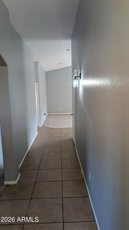 a view of hallway with an empty room