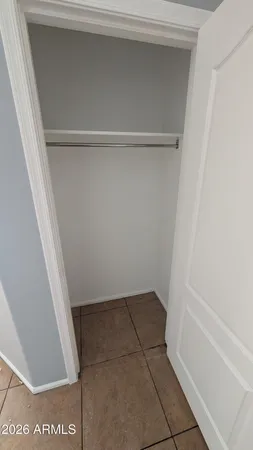a view of walk in closet with clothes
